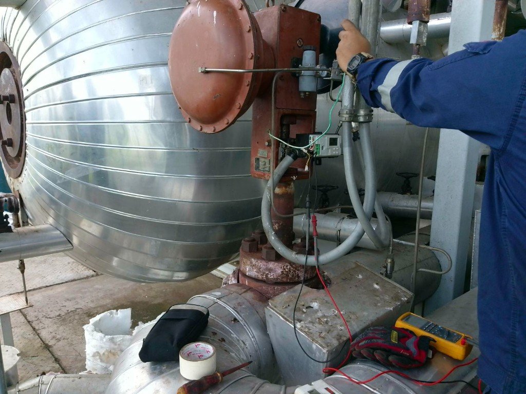 Technician testing a control valve with multimeter at Thatone